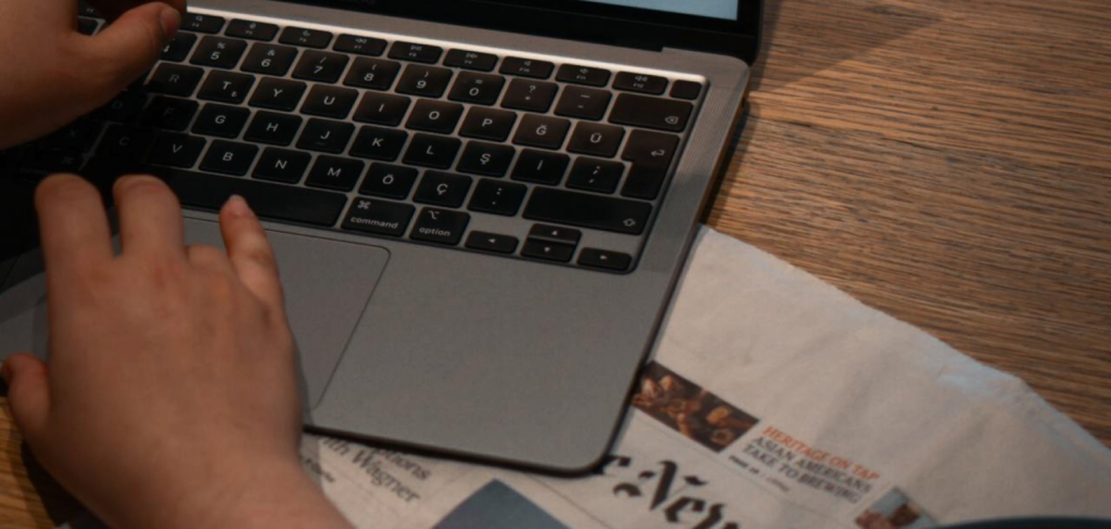 man browsing using laptop on desk